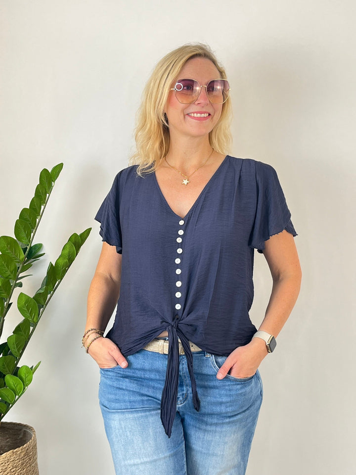Marineblaue Damenbluse mit Knotendetail am Saum und V-Ausschnitt