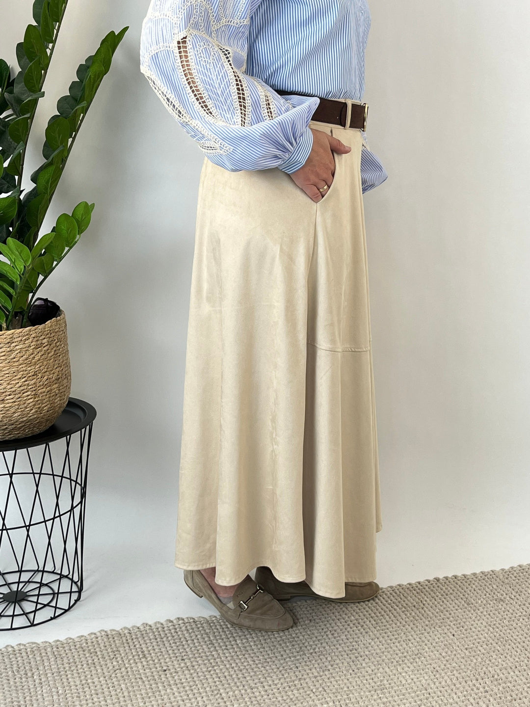 Close-up of side pocket on beige faux suede skirt with model&