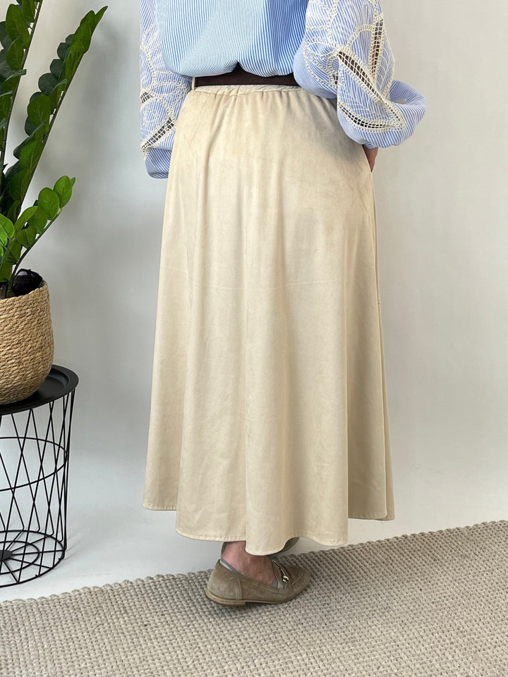 Back view of beige velour leather-imitate skirt showing smooth wide silhouette