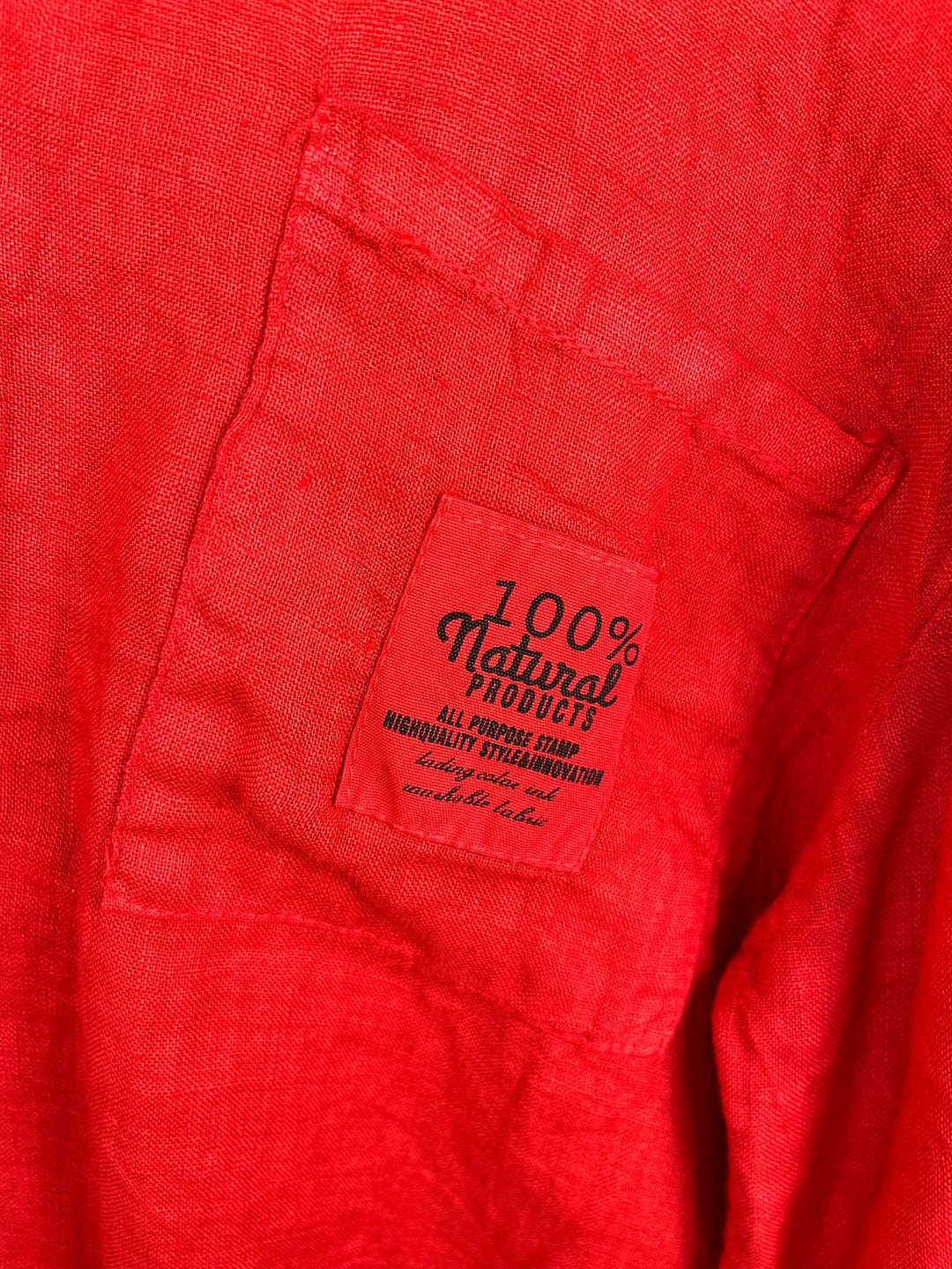 Detailaufnahme rote Leinenbluse mit Etikett-Aufnäher