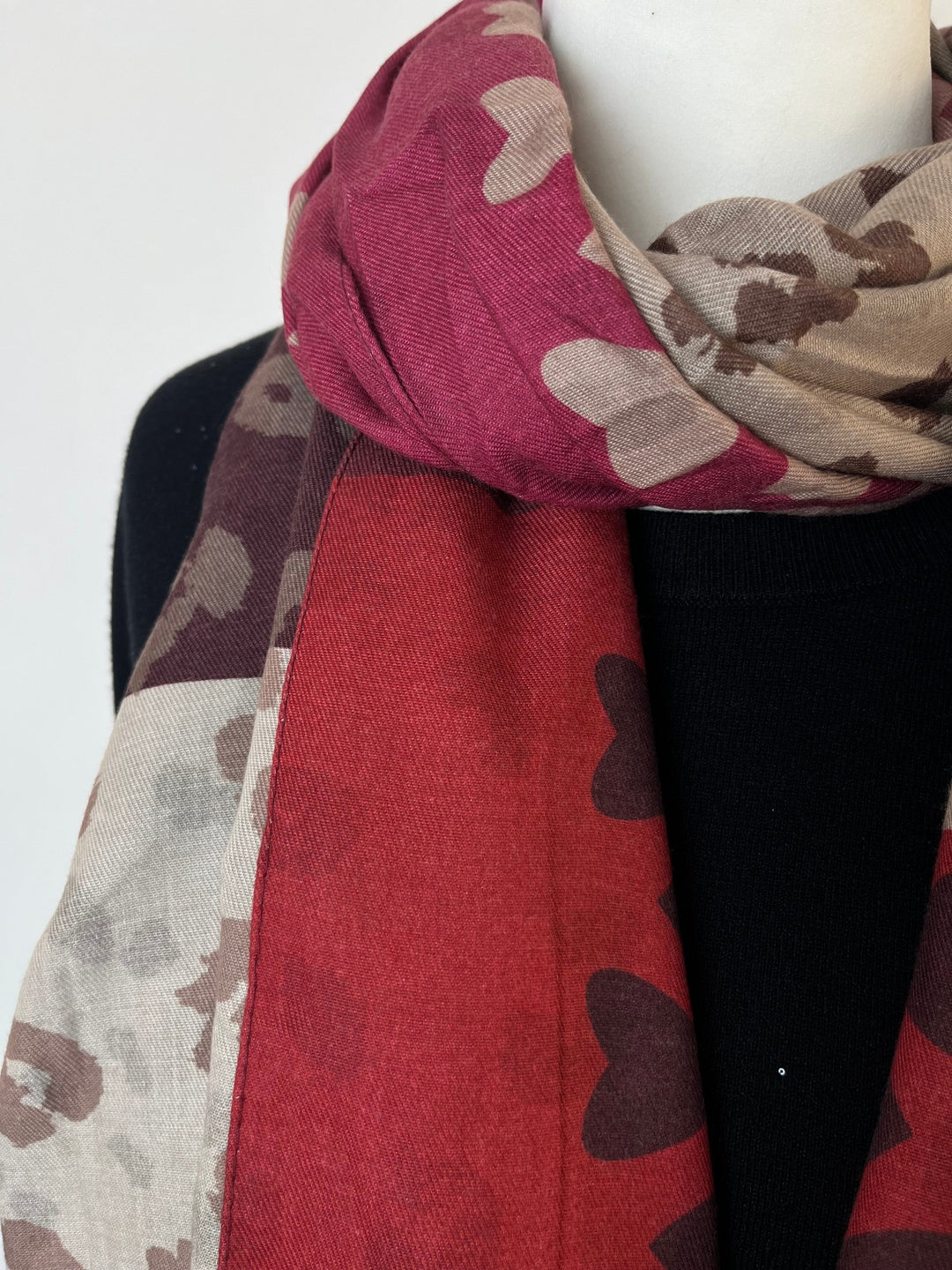 Weicher Wollschal mit Herz-Motiven um den Hals drapiert