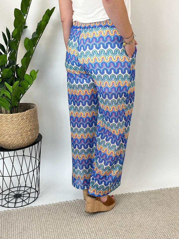 Back view blue multi zigzag wide leg pants fabric drape