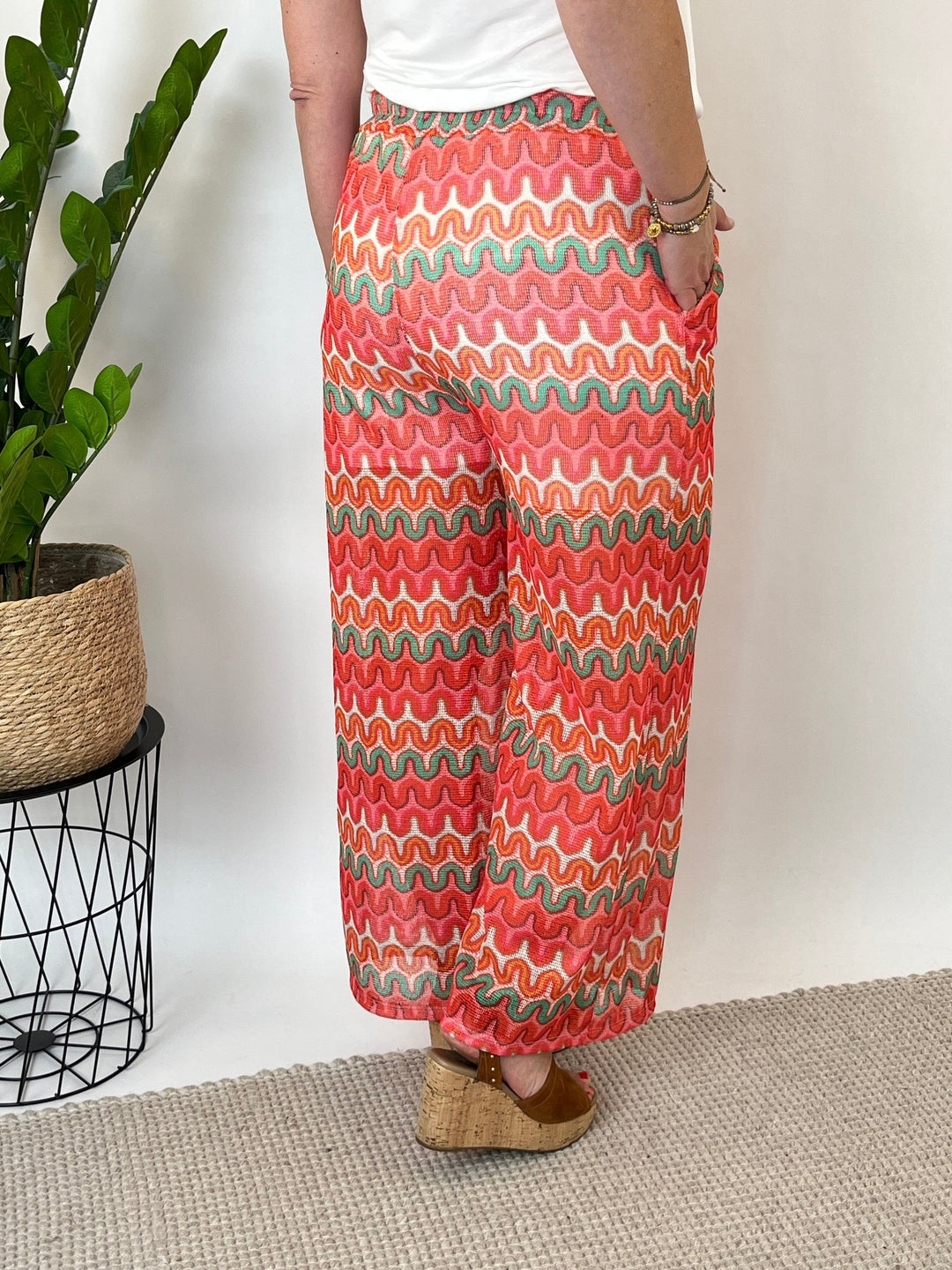Back view coral zigzag pattern wide leg pants side pocket