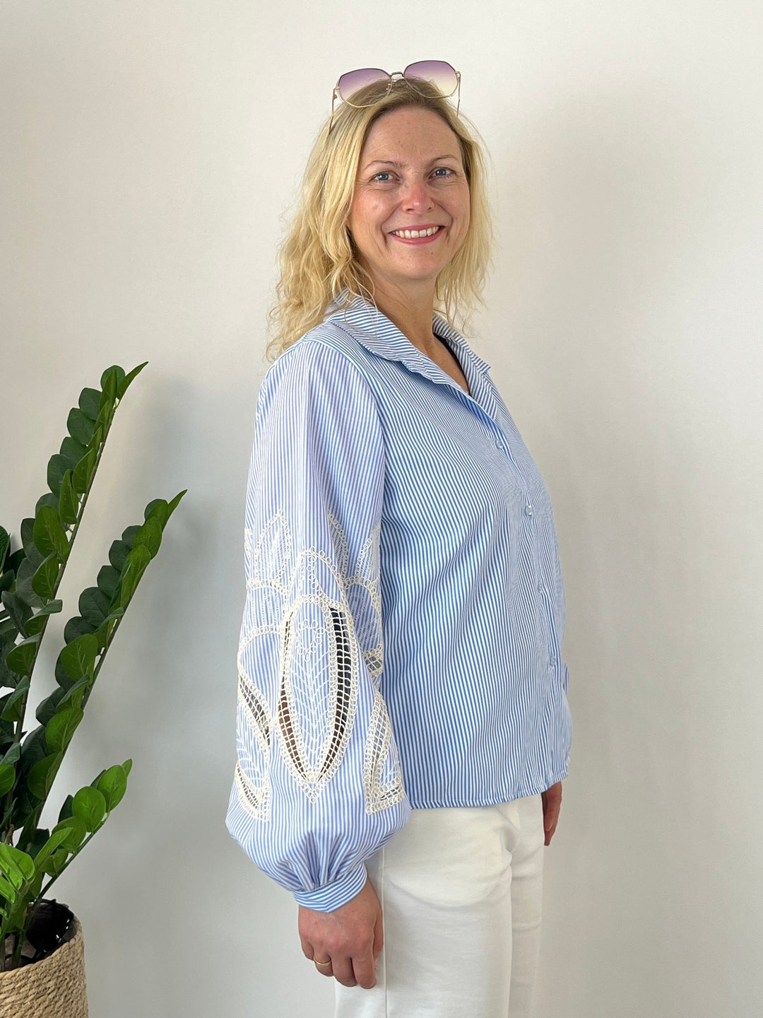 Seitenansicht der lockeren Bluse mit detailliertem Stickereimuster am Ärmel